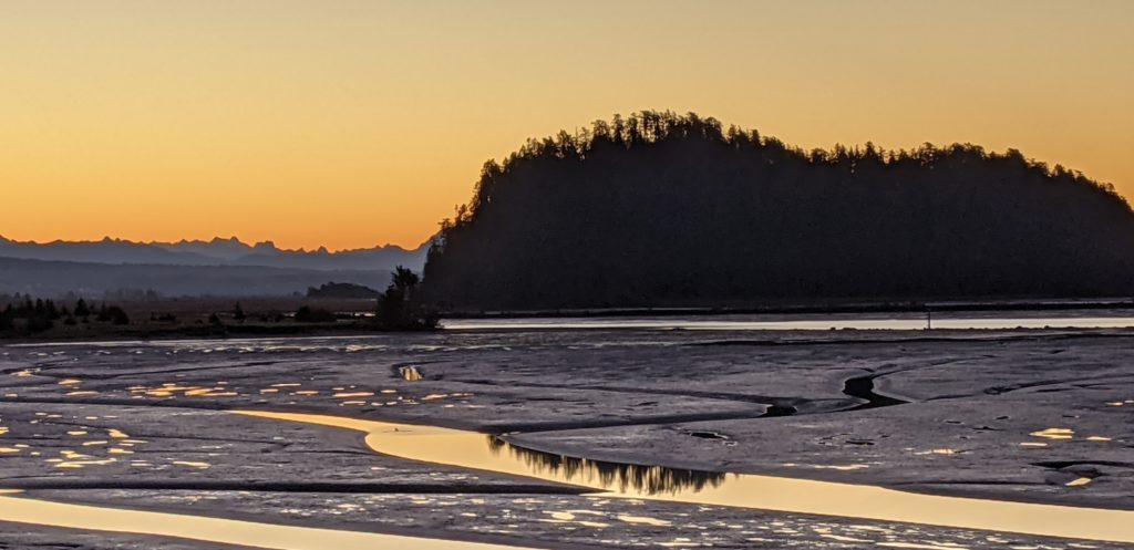 Dawn on Skagit Bay, with Ika Island in the foreground and reflections on the tidal flatlands. 