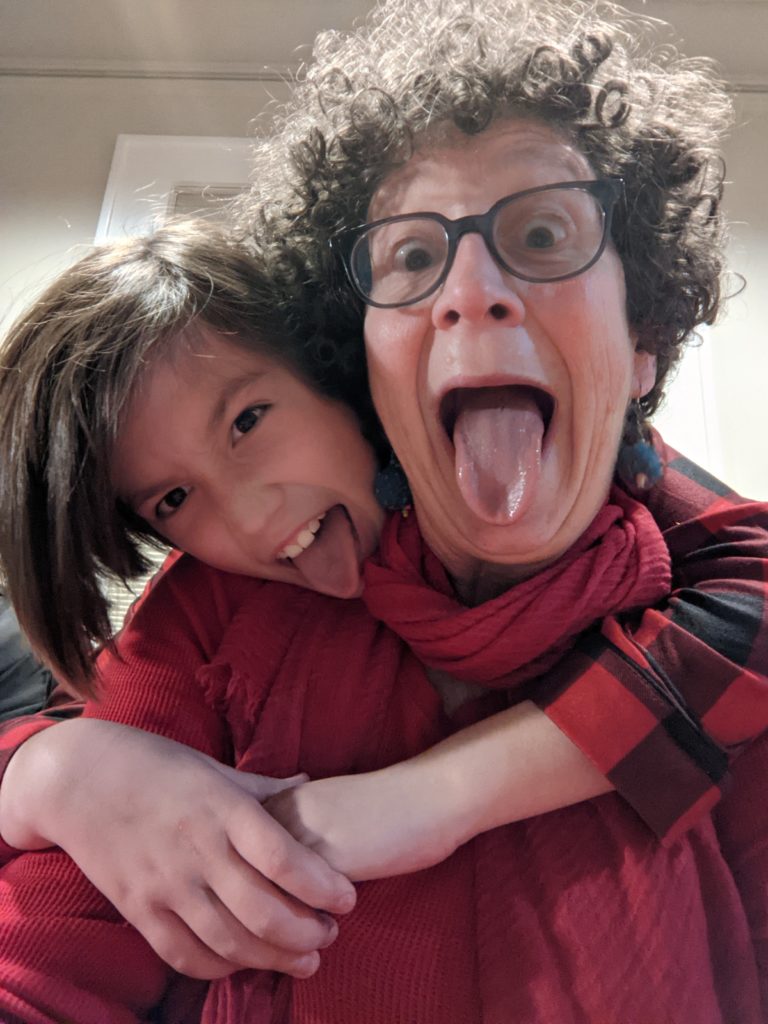 A picture of Nancy and her grandperson making funny faces.